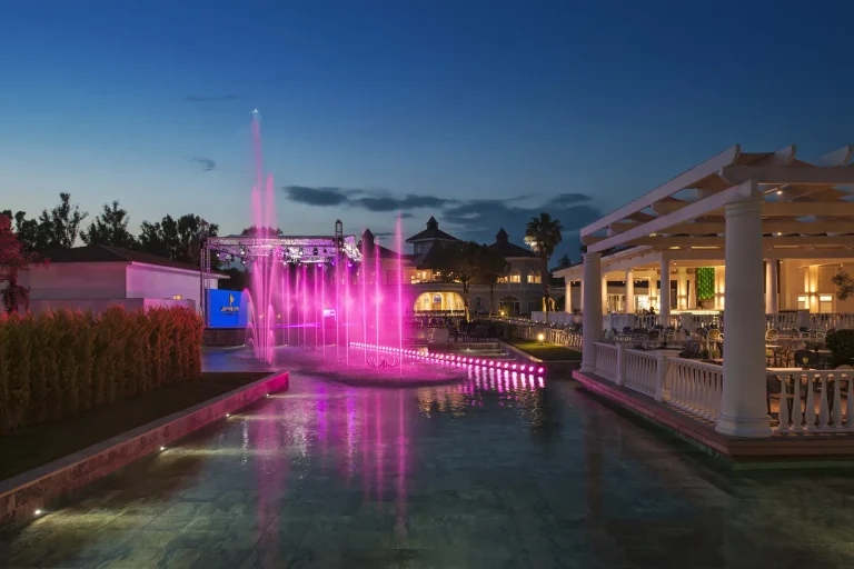 Illuminated fountains at dusk in front of the terrace at Sirene Belek